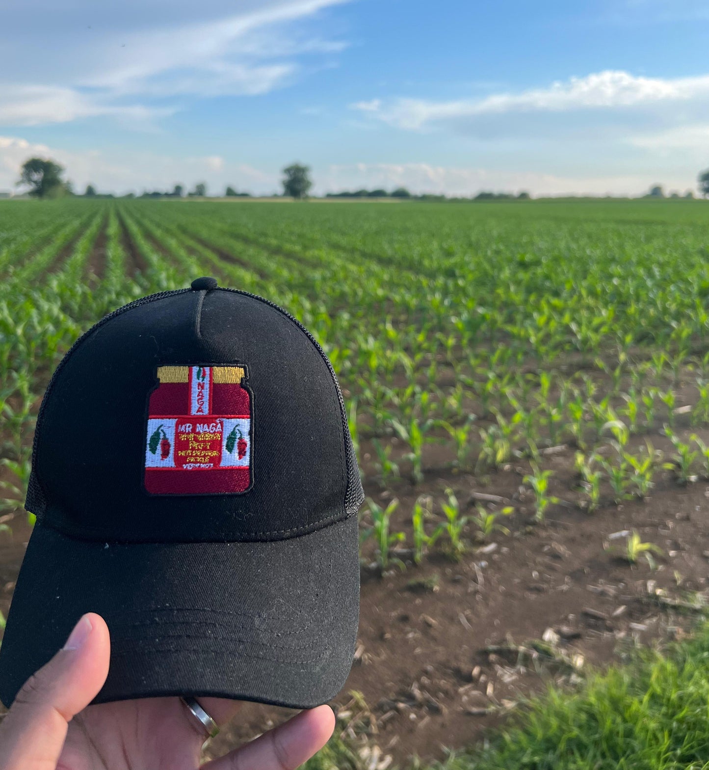 Image of the Mr Naga trucker hat in a Naga farm